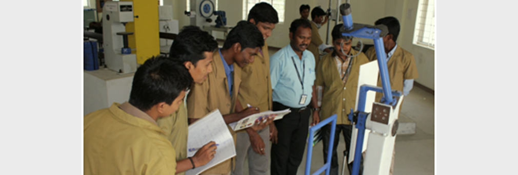 Alpha students using lab equipments in college Strength Of Material laboratory